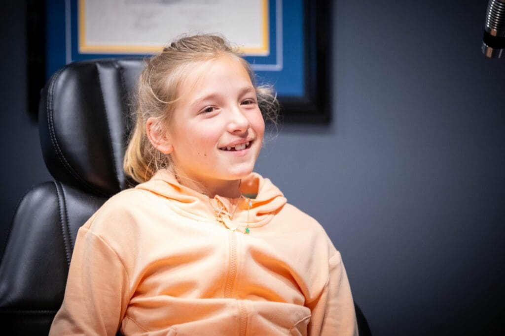 Child sitting in dental chair smiling